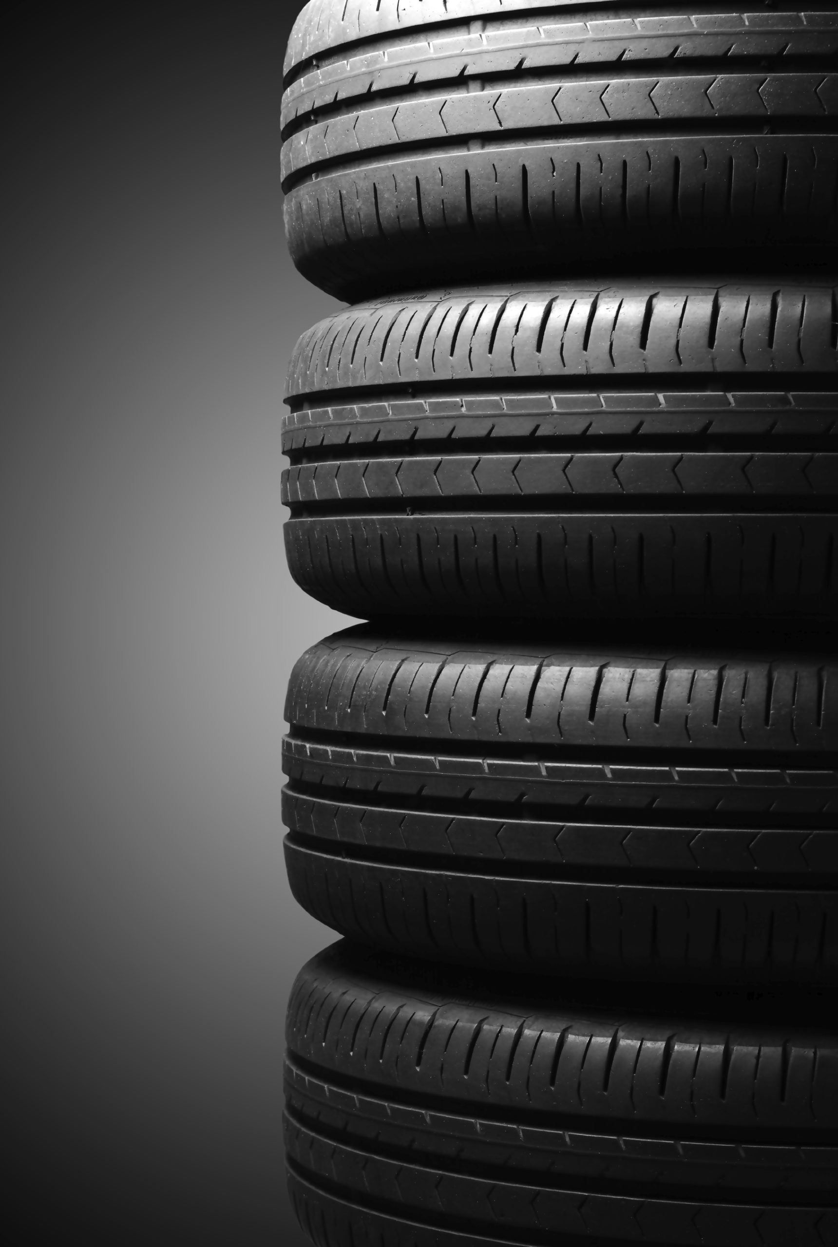 Four car summer tires in dramatic lighting